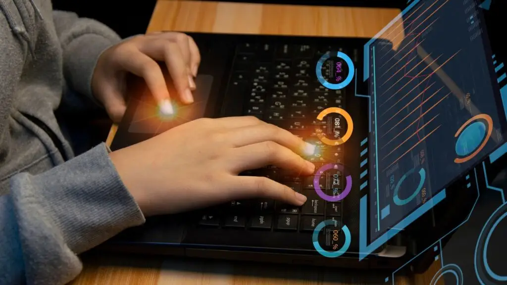 Image of a person using a laptop with holographic data analytics displays, showing charts and circular metrics, highlighting advanced data interaction.